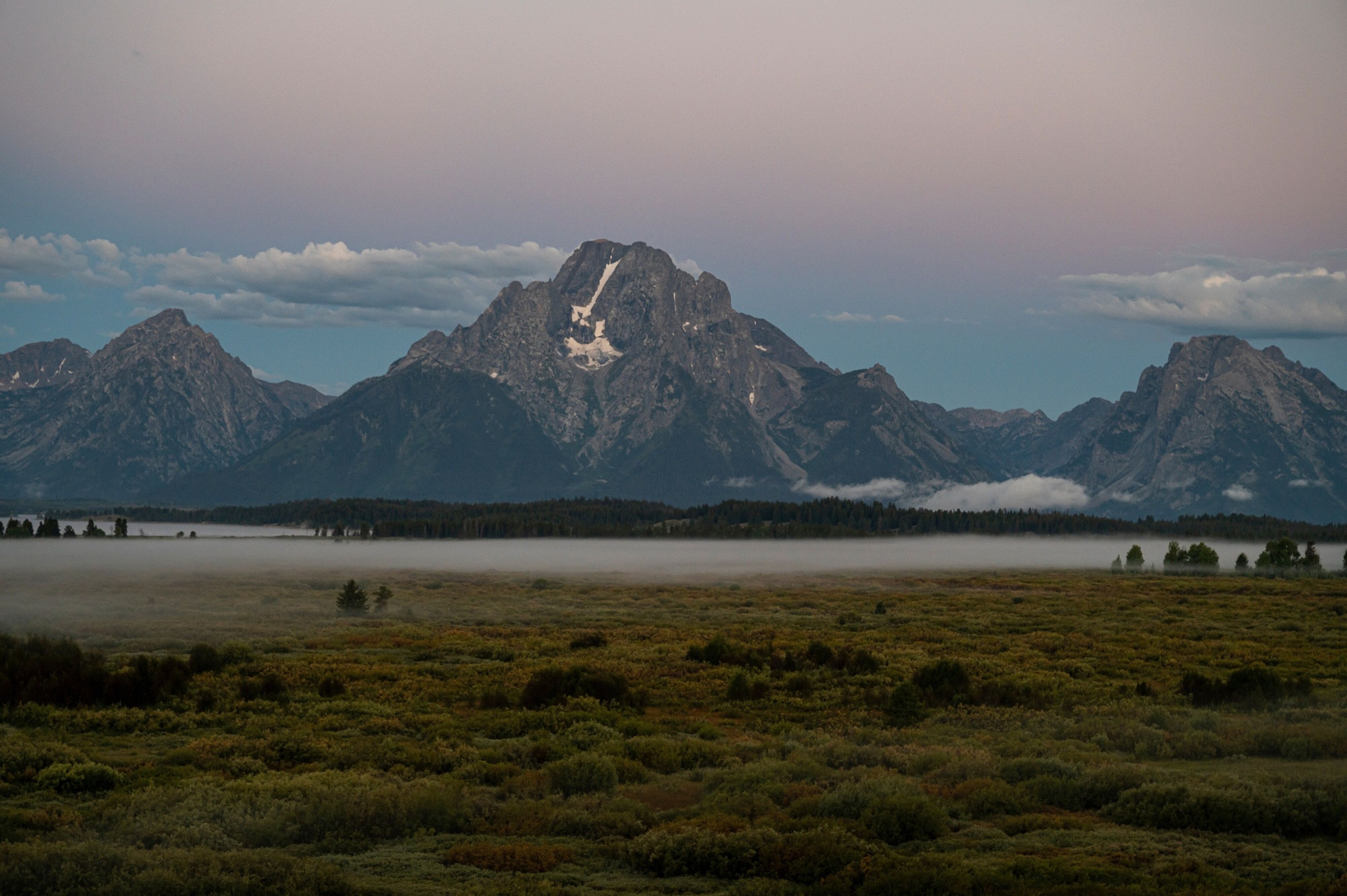 The Grand Tetons at sunrise at the Jackson Hole economic symposium in Moran, Wyoming, US, on Thursday, Aug. 24, 2023.